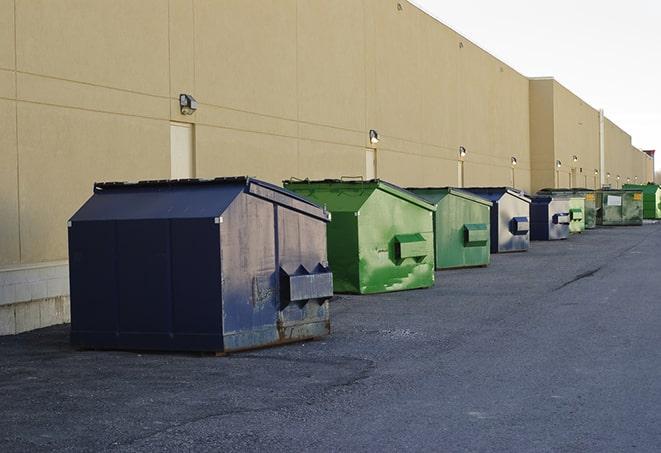 a fleet of red and blue construction dumpsters available for use in Battlement Mesa CO